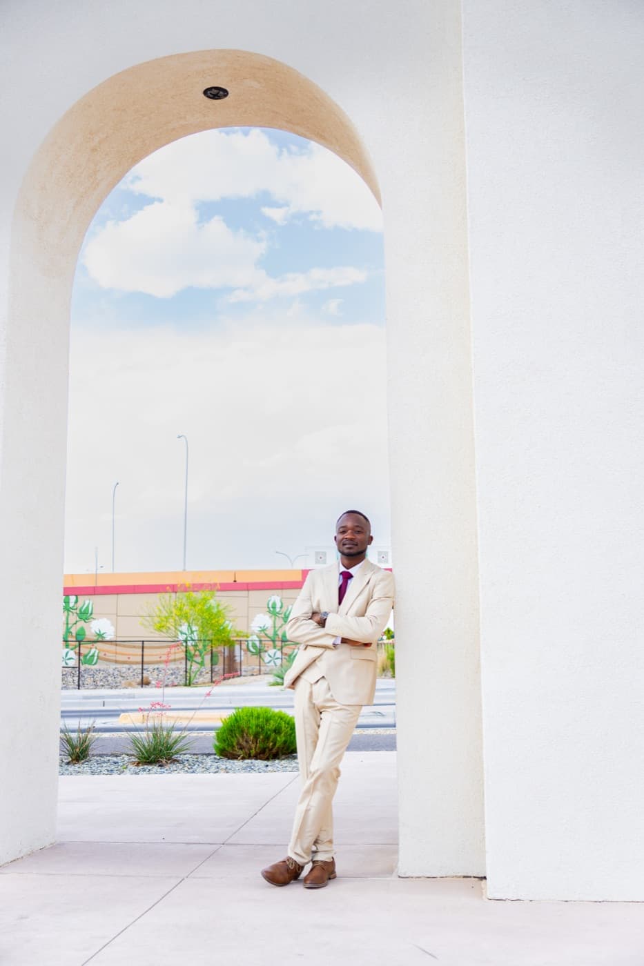 Oluwatosin Abideen Saibu standing beneath an architectural archway